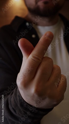 Man making heart gesture with his fingers demonstrating love and appreciation to the person opposite him