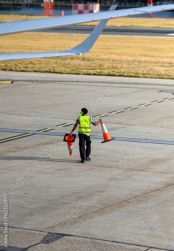 men putting the cones in airport