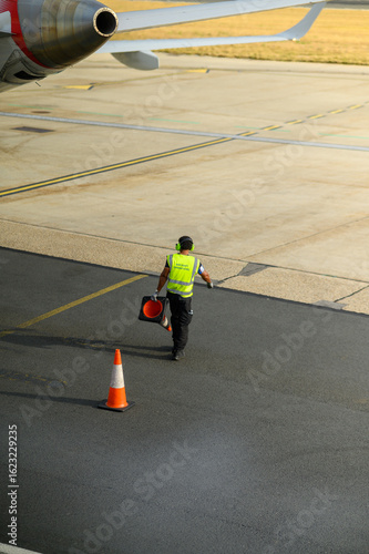 men putting the cones in airport