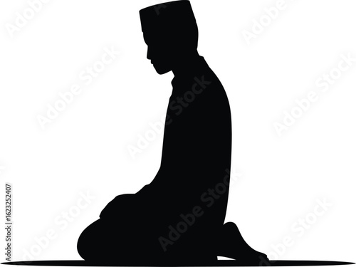 Silhouette of a muslim man praying on a prayer mat