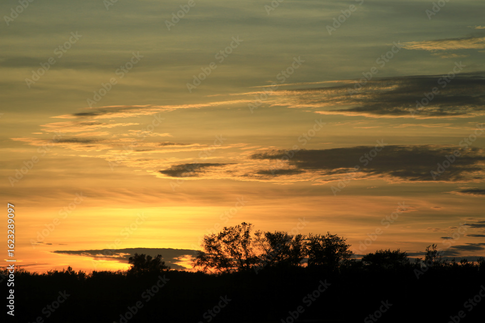 Fototapeta premium Golden sunset casting a warm glow over the seaside horizon at Longgang Miaoli Taiwan, captured in summer 2011 for a tranquil scene.