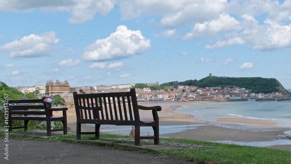 Bench overlooking the South Bay in the seaside town of Scarborough on the North Yorkshire coast. Panning shot Bench overlooking the South Bay in the seaside town of Scarborough on the North Yorkshire coast. Panning shot