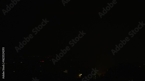 Night thunderstorm with striking lightning in dense clouds