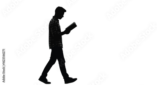 Silhouette of a Young Man Reading a Book While Walking, Depicting Education, Knowledge