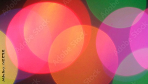 A soft-focus abstract light leak texture with vivid red, orange, and pink hues blending smoothly.