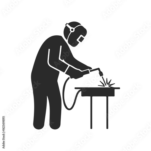 Silhouette of welder working with tool on metal table