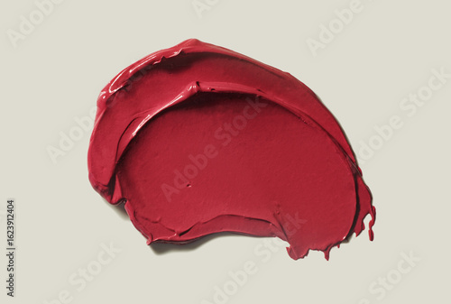 Papier peint Lipstick dark red burgundy cherry smudge sample swatch isolated on beige neutral background texture