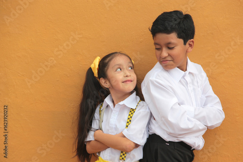 Quadro em tela Latino older brother and younger sister play and tease each other during their f