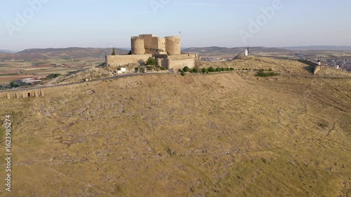 Aerial view of sunrise over the Medieval Castle of Consuegra and his windmills in Toledo, Spain.