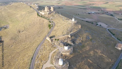 Aerial view of sunrise over the Medieval Castle of Consuegra and his windmills in Toledo, Spain.