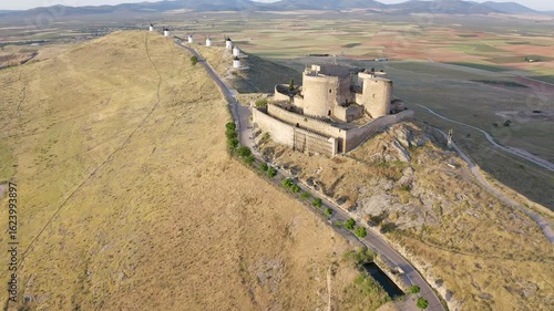 Aerial view of sunrise over the Medieval Castle of Consuegra and his windmills in Toledo, Spain.