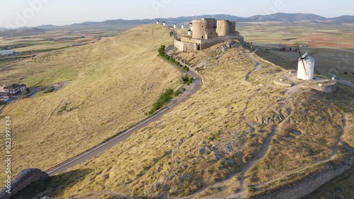 Aerial view of sunrise over the Medieval Castle of Consuegra and his windmills in Toledo, Spain.