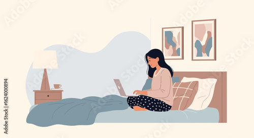 Woman working on laptop in bed demonstrates modern lifestyle and comfortability