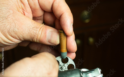 Mature man loading revolver