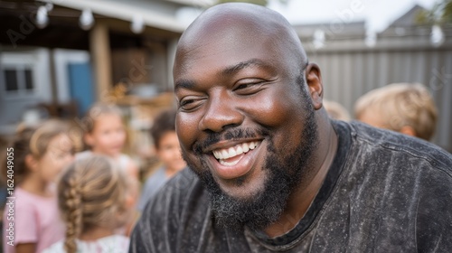 Wallpaper Mural Joyful Man Smiling While Surrounded by Cheerful Children in Outdoor Setting Torontodigital.ca