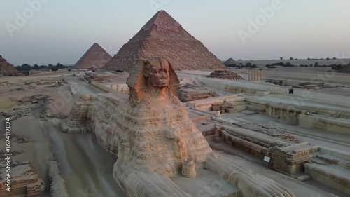 The majestic Great Sphinx monument guarding the historic pyramids on the Giza plateau. An iconic ancient Egyptian landmark at dusk.