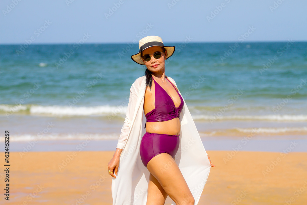 Woman in purple bikini happy on beach Woman in purple bikini happy on beach