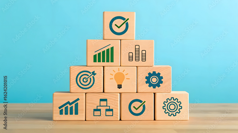 Fototapeta premium Wooden cubes stacked in pyramid with business icons