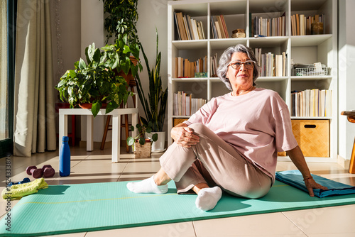 Senior Woman Enjoys Stretching Hip Mobility at Home in a Bright and Inviting Living Space
