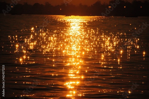 Golden sun reflecting on water surface at sunset