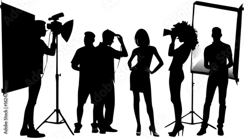 Silhouette of photographer with camera and models in a studio setting with lighting equipment present | editable eps vectors
