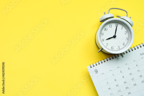 close up of calendar and clock on the yellow table background, planning for business meeting or travel planning concept