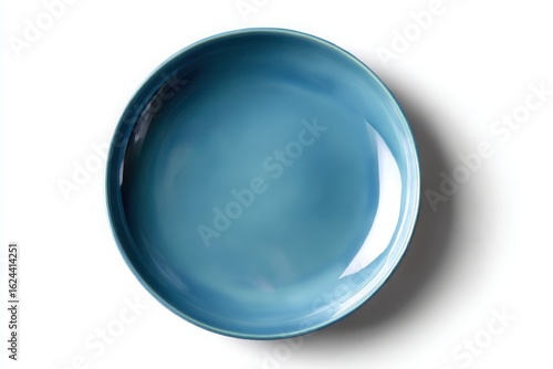 A single teal ceramic plate with a glossy finish isolated on white background