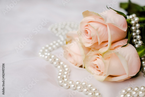 Fototapeta Naklejka Na Ścianę i Meble -  The branch of pink rose on white fabric background
