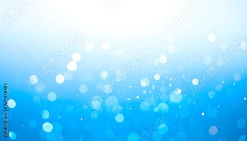 Soft blue light particles and glowing dust floating background.