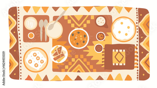 Overhead view of a table setting with various dishes and decorative patterned tablecloth design