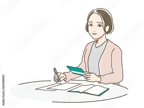 通帳をみながら書類に記入する女性