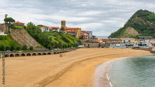 Fotografi Panoramic view of the tourist town of Getaria with its cathedral and golden sandy beaches, Basque Country