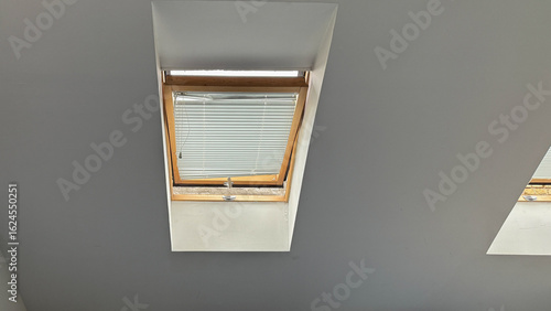 Fotografie Sunlight trickles through slanted window blinds, whispering secrets to insomniac