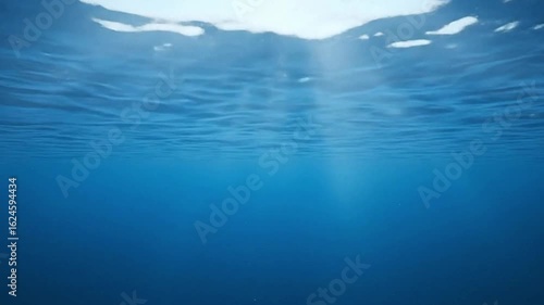 Wallpaper Mural Underwater view with sunbeams piercing through rippled surface Dark blue clear water Torontodigital.ca