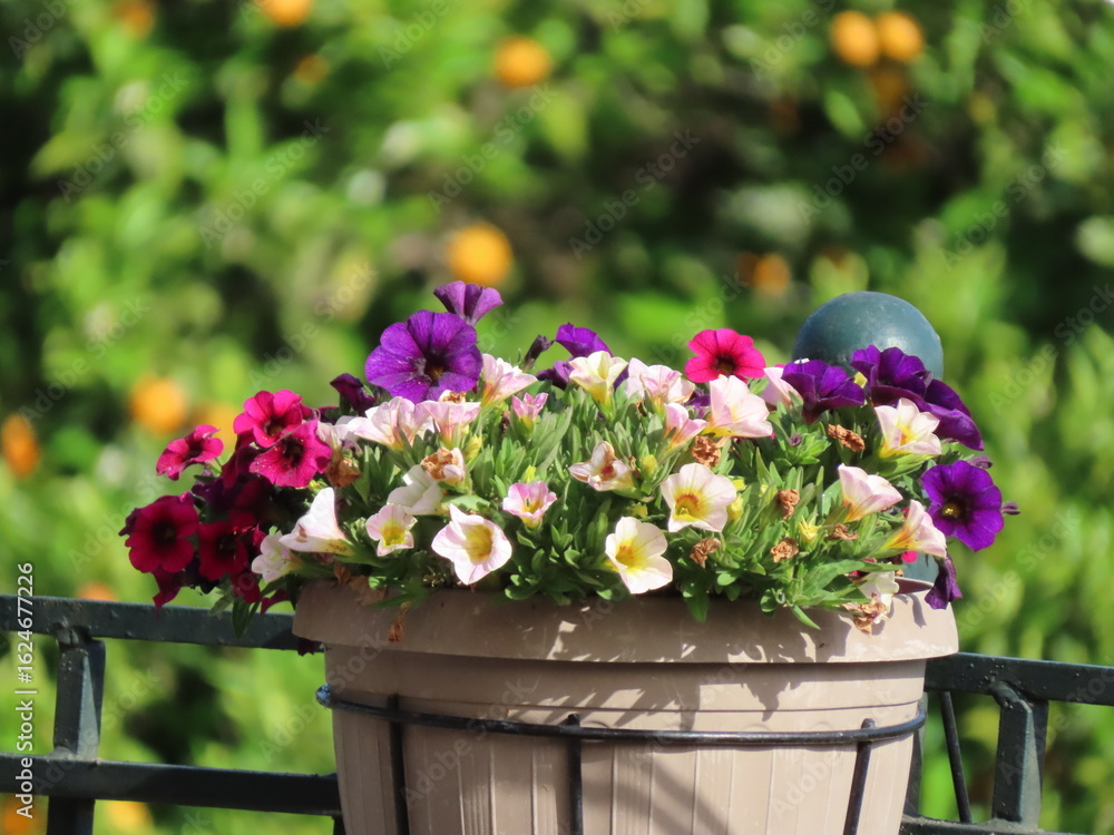 Naklejka premium A serene village scene where colorful flowers bloom alongside lush trees, capturing the peaceful rhythm of rural life and the beauty of nature in harmony with traditional living.