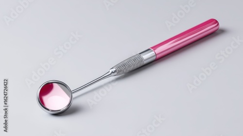 Wallpaper Mural Dental examination tool with a pink handle resting on a light background Torontodigital.ca