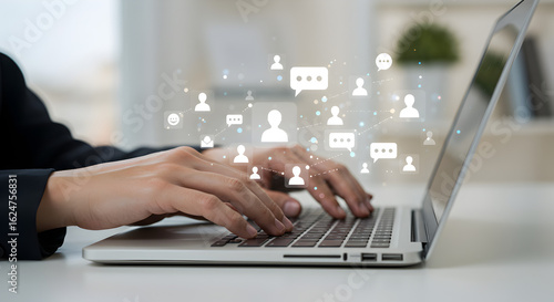 Person typing on a laptop with a network of user and chat bubble icons. Represents social networking, online communication, and community.