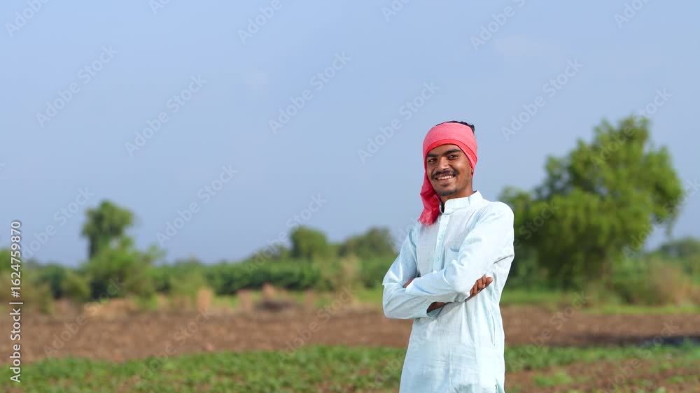 Young Indian farmer standing confidently at agriculture field Young Indian farmer standing confidently at agriculture field