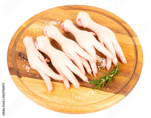 “Fresh Raw Chicken Feet Neatly Arranged on a Wooden Cutting Board, Isolated on Transparent Background”.