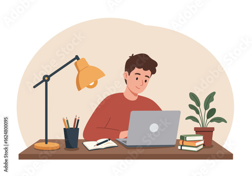 Young man diligently works on laptop at home desk, surrounded by books and study supplies.