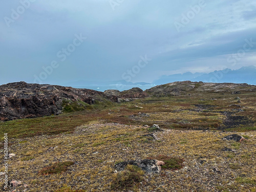 Canvas Print A scenic view from Scoresby Land in Greenland with mountains in the distance acr