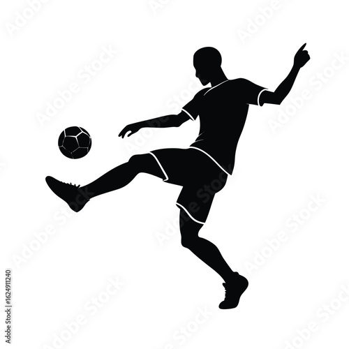Silhouette of a soccer player kicking a ball