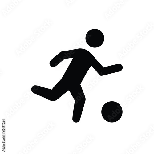 Silhouette of a person kicking a soccer ball
