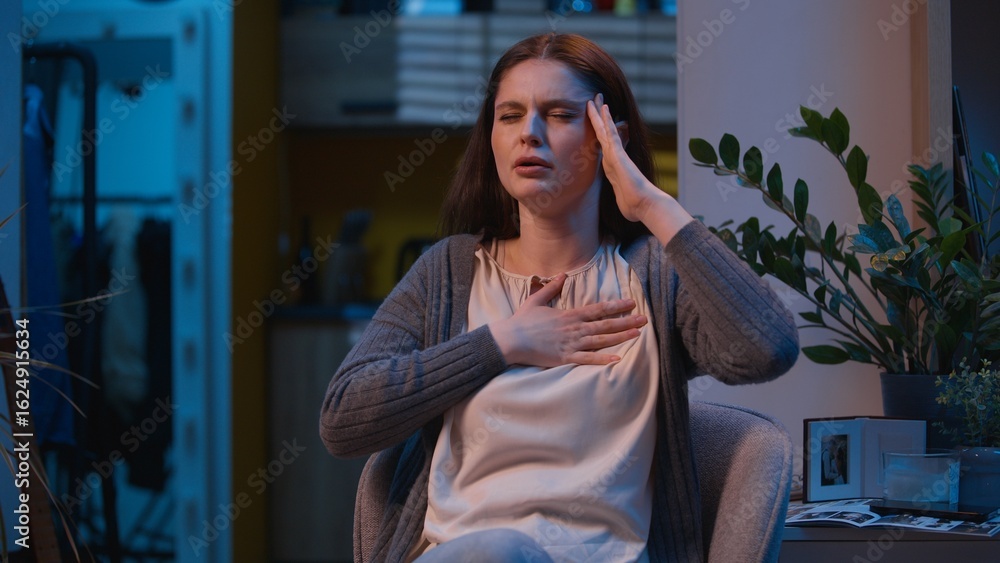 Fototapeta premium Caucasian woman suffer headache heart attack pain in chest sick ill unwell girl female at night evening home feel stress health problem ache heartache hurt in breast symptom cardiac pressure medicine