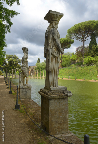 Ancient pool called Canopus, surrounded by greek sculptures in Villa Adriana (Hadrian's Villa) and reflections in water in Tivoli, Italy, UNESCO world heritage site
