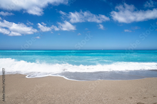 Fototapeta Naklejka Na Ścianę i Meble -  Tropical sand beach and blue sky, hot summer day, waves on the beach	
