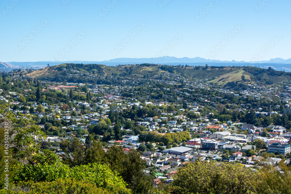 Fototapeta premium Panoramic City View Surrounded by Hills