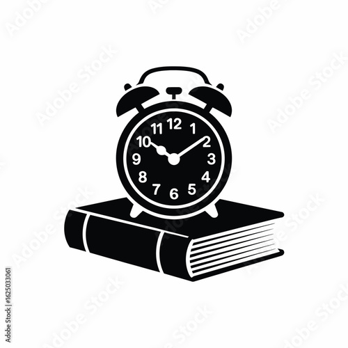 Classic alarm clock resting on an open book silhouette