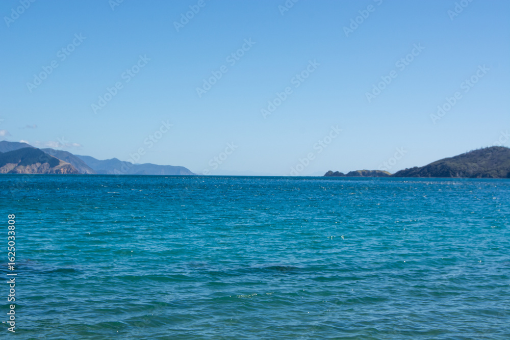 Fototapeta premium Serene Ocean View Under Clear Blue Sky