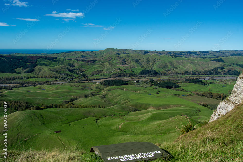 Naklejka premium Panoramic View of Lush Green Hills and River